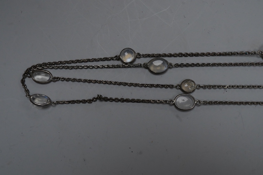 A silver and moonstone longchain necklace, set with cabochon moonstones, connected by a fine link chain, length 128cm, Condition: overall good condition, attractive moonstones and nice design. Silver with typical tarnish